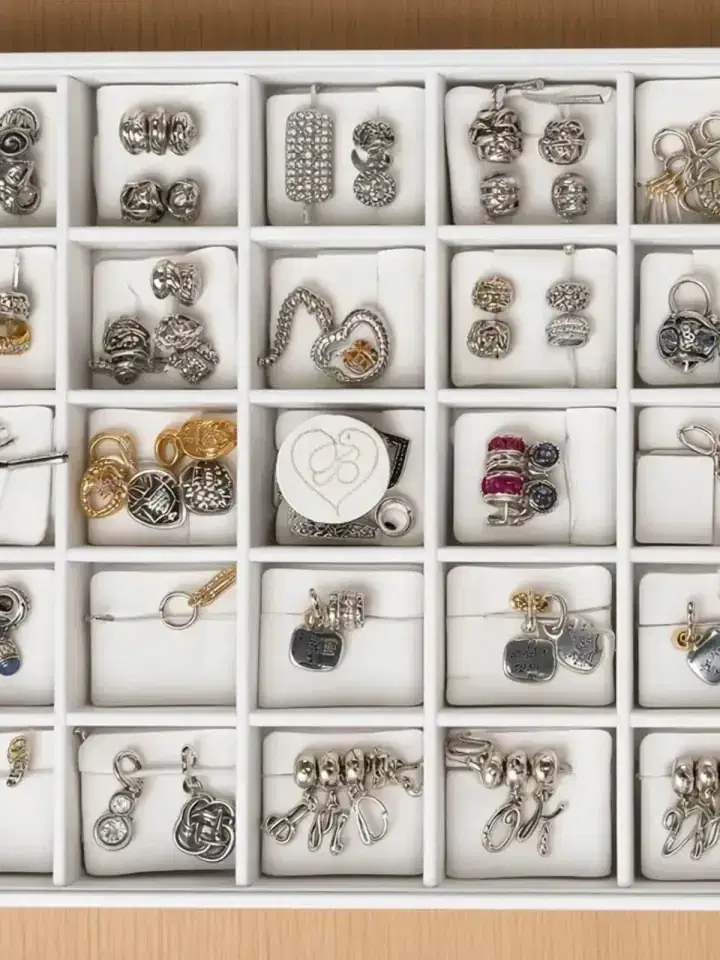 White tray of silver charm bracelets and starter links